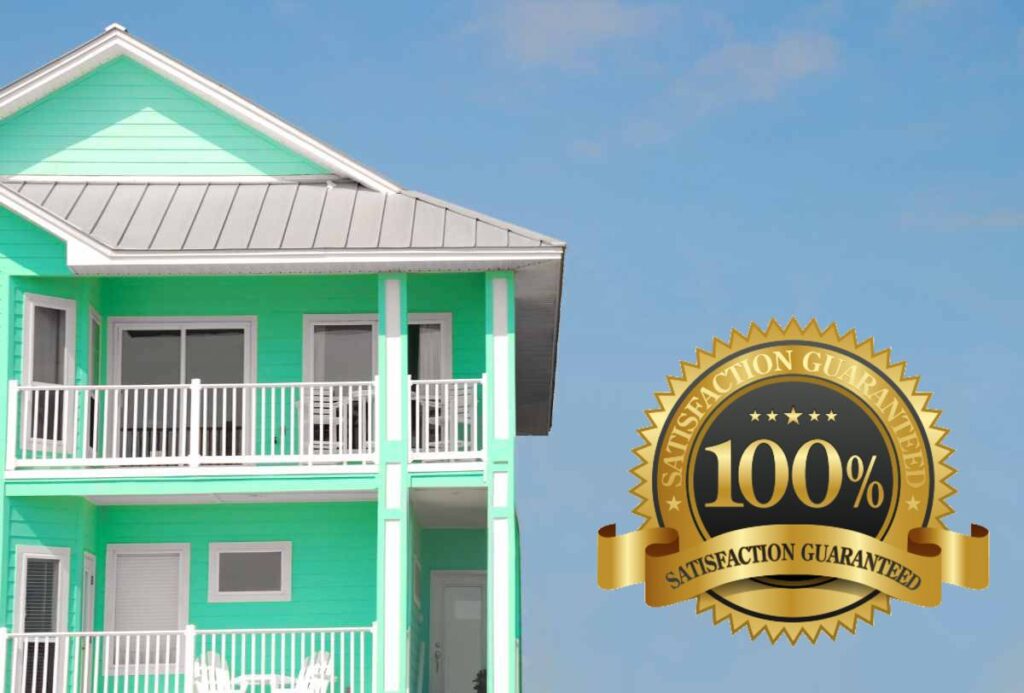 Image shows two story, green, tropic looking Florida home with metal roof. A 100% satisfaction guaranteed medallion is superimposed over the photo.