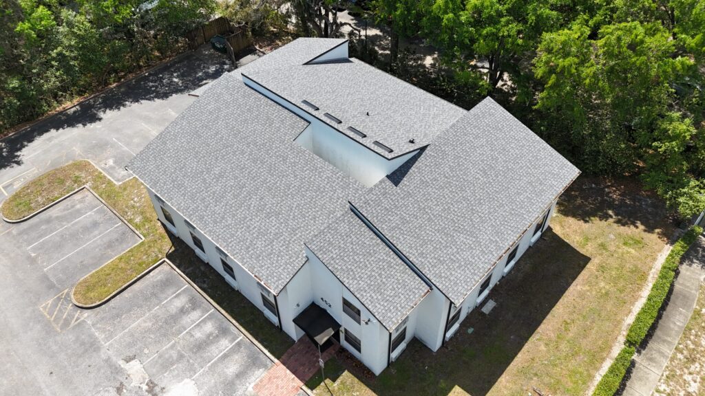 Image shows a small office building with a newly installed roof by Eave & Gable roofing